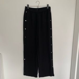 Wide-leg black pants with side-button detail
